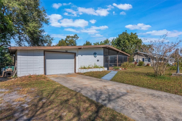 ranch-style house with a garage, a sunroom, and a front lawn