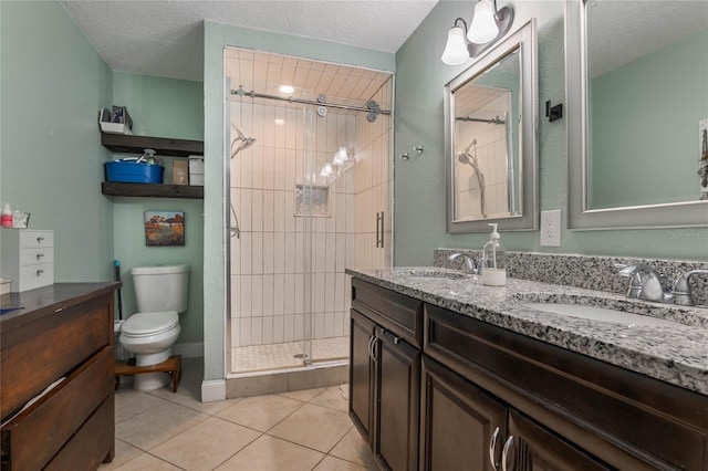 full bath with double vanity, a stall shower, a sink, and tile patterned floors