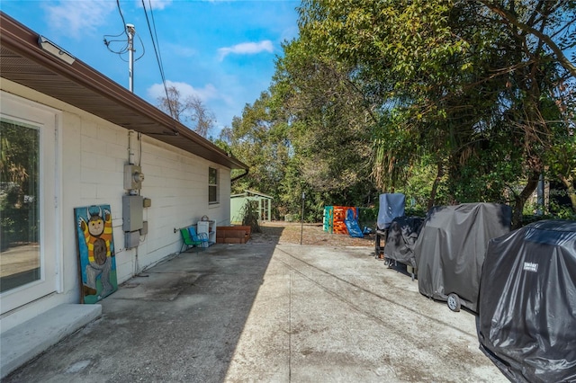 view of side of property with a patio area