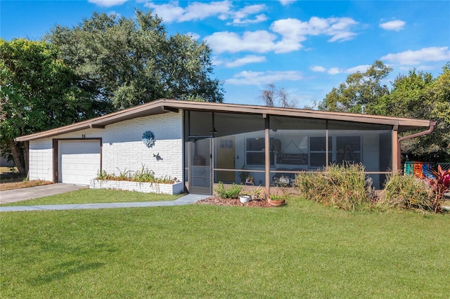 view of front of house with a garage, brick siding, a sunroom, driveway, and a front lawn