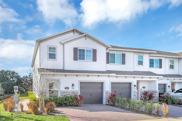 townhome / multi-family property featuring a garage