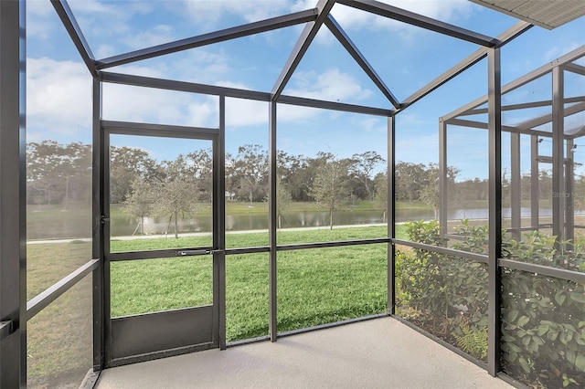 unfurnished sunroom with a water view and a wealth of natural light