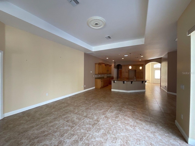 unfurnished living room with light tile patterned flooring