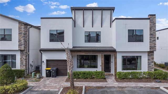 view of front of house featuring cooling unit and a garage