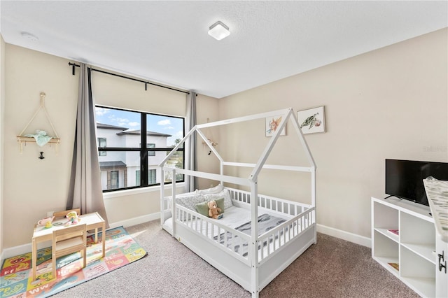 carpeted bedroom with a textured ceiling