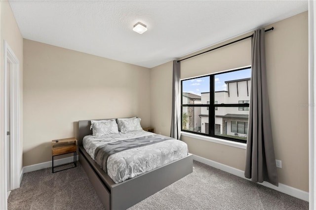 bedroom with carpet floors and a textured ceiling