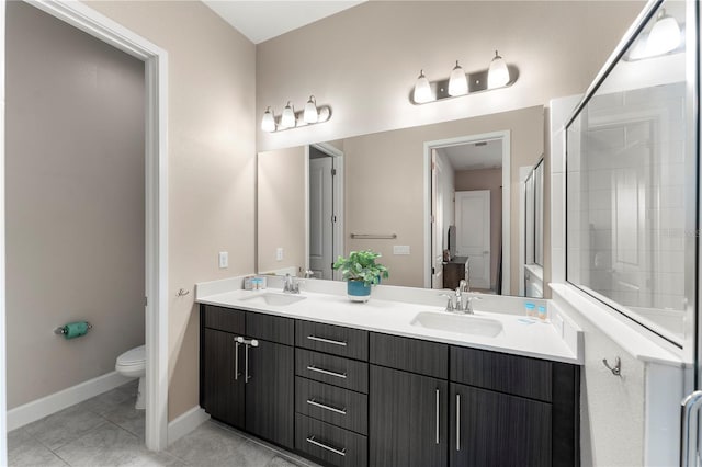 bathroom featuring vanity, an enclosed shower, tile patterned floors, and toilet