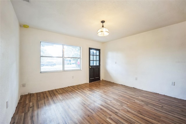 unfurnished room featuring hardwood / wood-style flooring