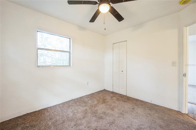 spare room featuring carpet floors and ceiling fan