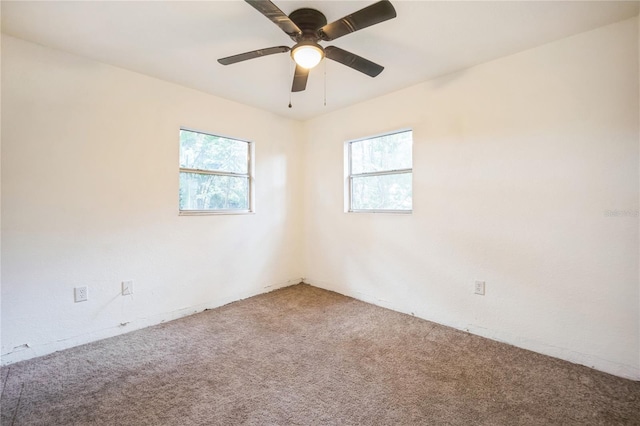 carpeted empty room featuring ceiling fan