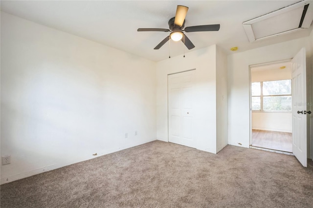 unfurnished bedroom featuring carpet flooring, ceiling fan, and a closet