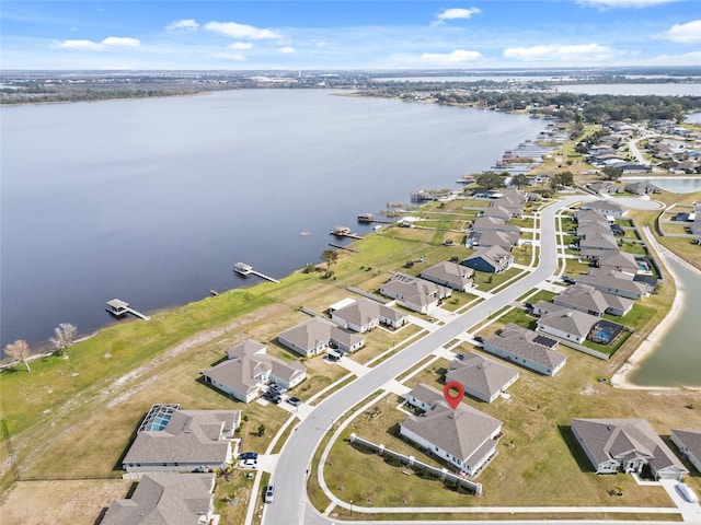 drone / aerial view with a residential view and a water view