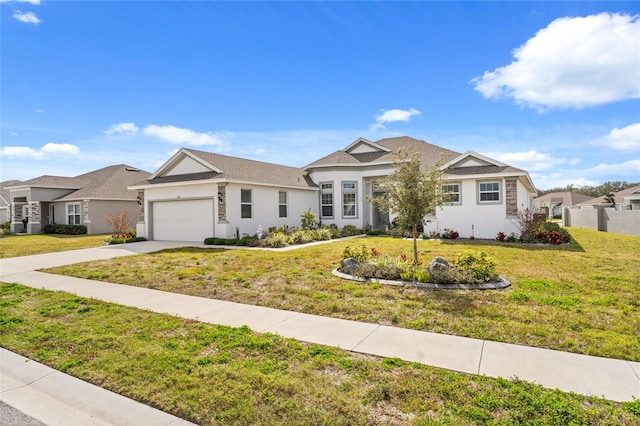 single story home featuring a garage and a front yard