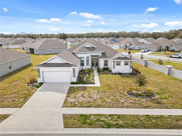 view of front of house featuring a garage and a front yard