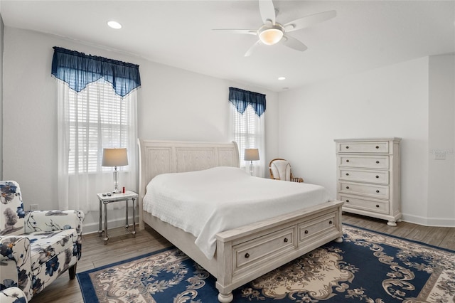 bedroom featuring recessed lighting, baseboards, wood finished floors, and a ceiling fan