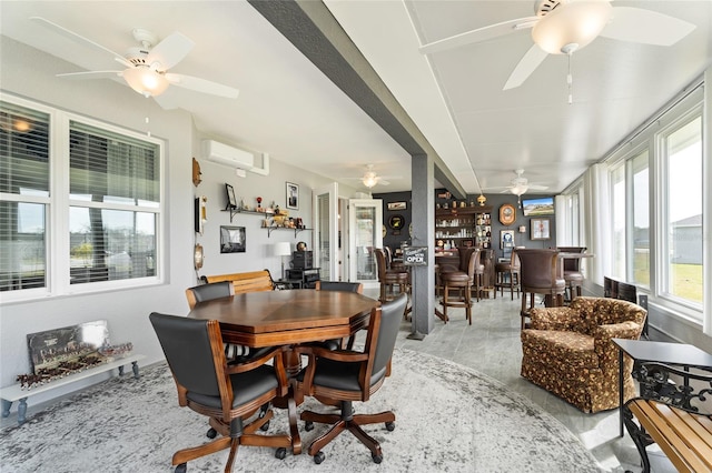 dining room with ceiling fan, a wall mounted AC, and a dry bar
