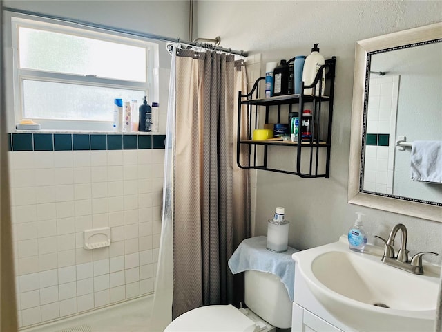 bathroom featuring vanity, toilet, and curtained shower