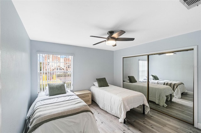 bedroom featuring a closet, ceiling fan, and light hardwood / wood-style flooring