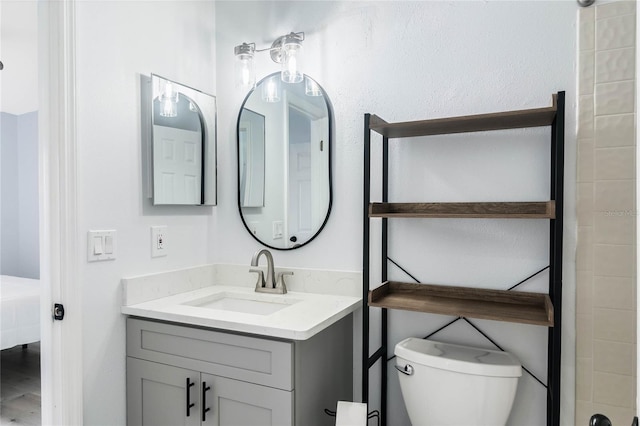 bathroom featuring vanity and toilet