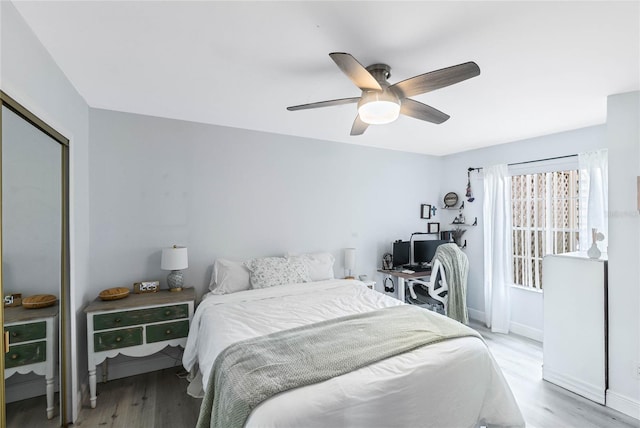 bedroom with a closet, ceiling fan, and light wood-type flooring