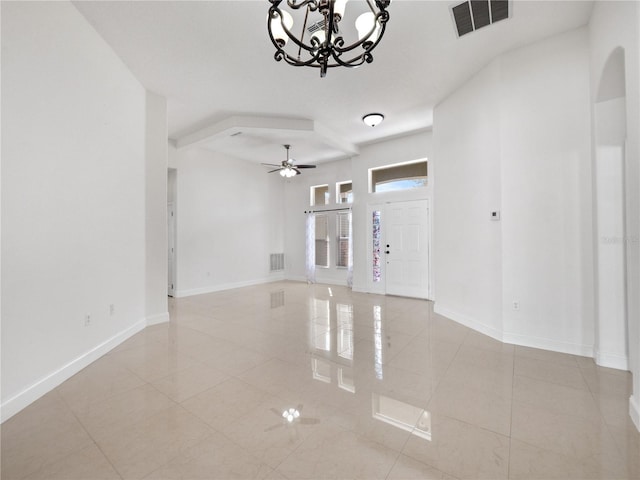 foyer entrance featuring ceiling fan with notable chandelier and light tile patterned floors