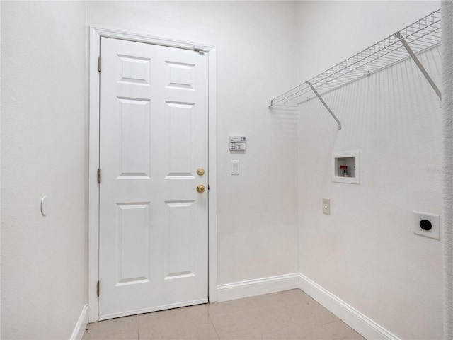 laundry area with hookup for a washing machine, hookup for an electric dryer, and light tile patterned floors