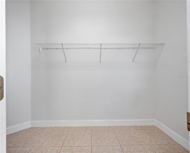 spacious closet featuring light tile patterned floors