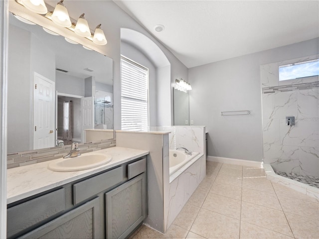 bathroom with tile patterned flooring, vanity, and shower with separate bathtub