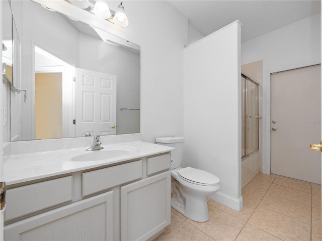 full bathroom with tile patterned flooring, vanity, shower / bath combination with glass door, and toilet