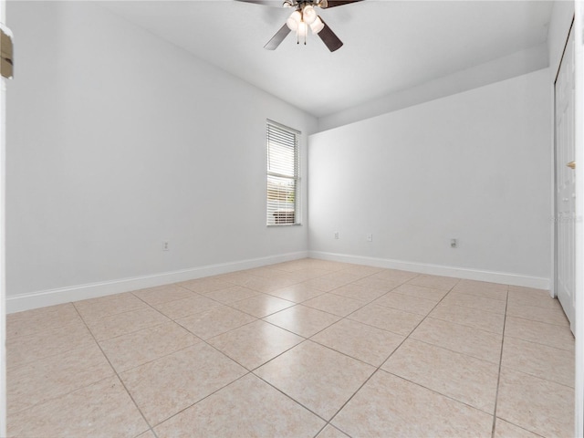 spare room with light tile patterned flooring and ceiling fan