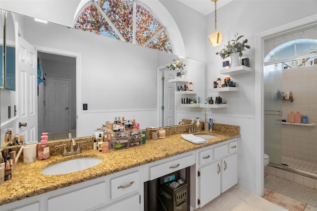 bathroom featuring an enclosed shower, vanity, tile patterned flooring, and toilet