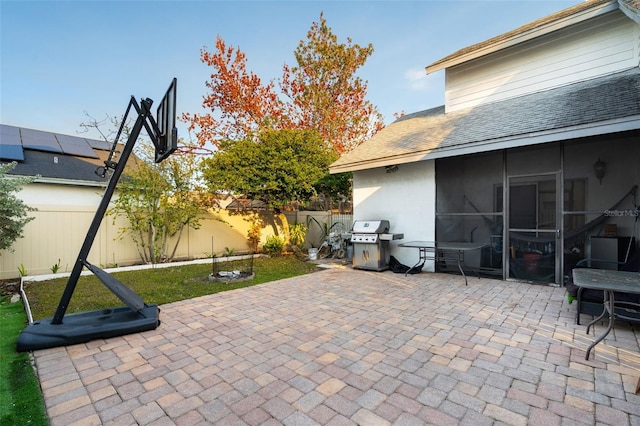 view of patio / terrace with a grill and a sunroom