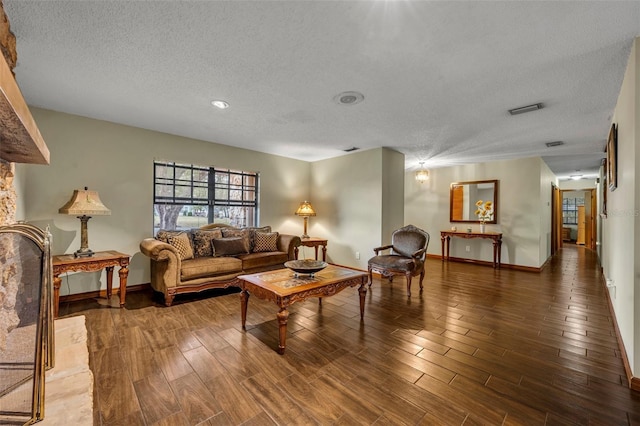 living room with dark hardwood / wood-style floors and a textured ceiling