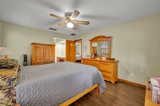 bedroom with hardwood / wood-style flooring, ceiling fan, and a textured ceiling