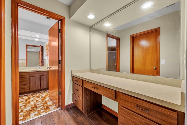 bathroom featuring vanity, a shower with door, and wood-type flooring