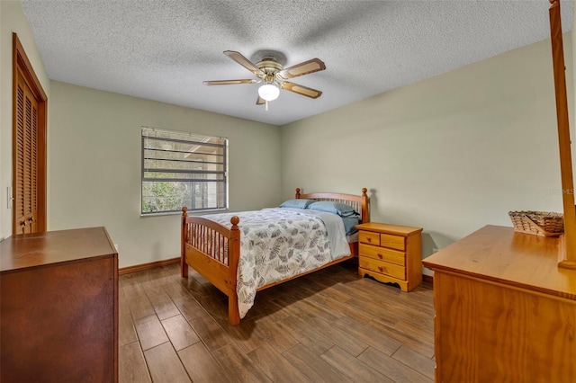 bedroom with ceiling fan, light hardwood / wood-style flooring, and a textured ceiling