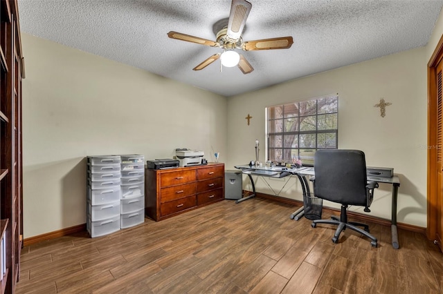 office with ceiling fan, dark hardwood / wood-style flooring, and a textured ceiling