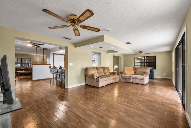 unfurnished living room featuring hardwood / wood-style flooring and a textured ceiling