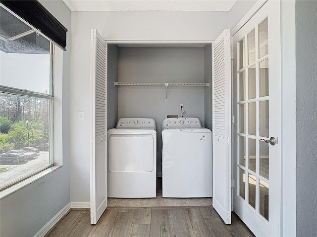 washroom featuring hardwood / wood-style flooring and washer and dryer