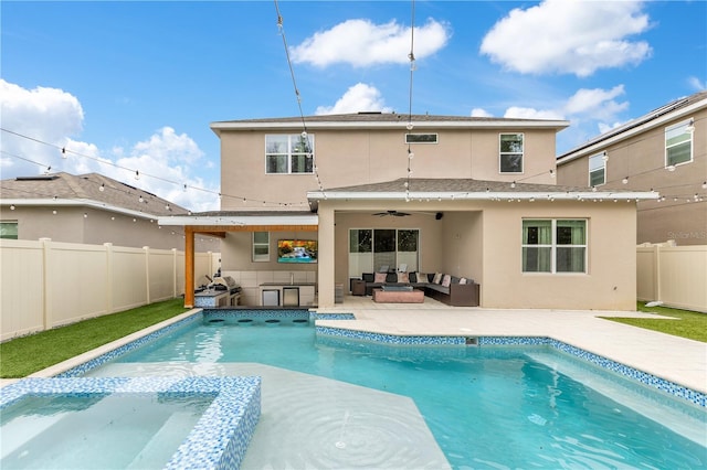 back of property featuring a fenced in pool, ceiling fan, and a patio area