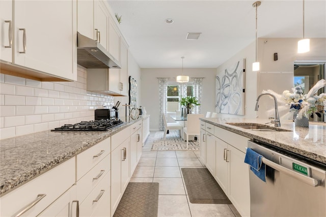 kitchen featuring pendant lighting, white cabinetry, light stone countertops, and appliances with stainless steel finishes