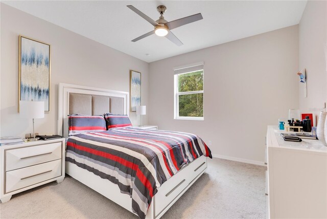 bedroom with light colored carpet and ceiling fan