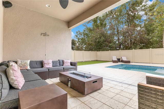 exterior space with ceiling fan, a patio area, and an outdoor living space with a fire pit