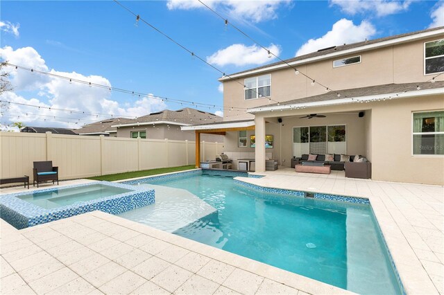 view of pool with outdoor lounge area, a patio, ceiling fan, and an in ground hot tub