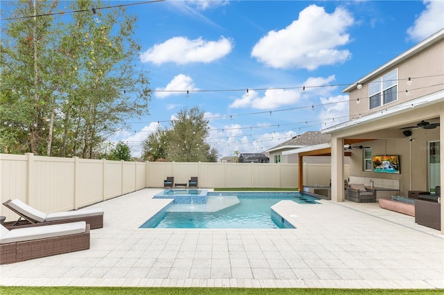 view of swimming pool featuring ceiling fan, an outdoor hangout area, and a patio