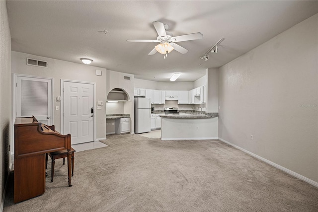 kitchen with stainless steel electric range, white cabinetry, white refrigerator, light colored carpet, and kitchen peninsula