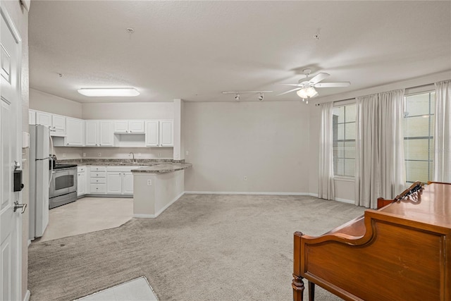 kitchen featuring white refrigerator, white cabinets, stainless steel electric range oven, light carpet, and kitchen peninsula