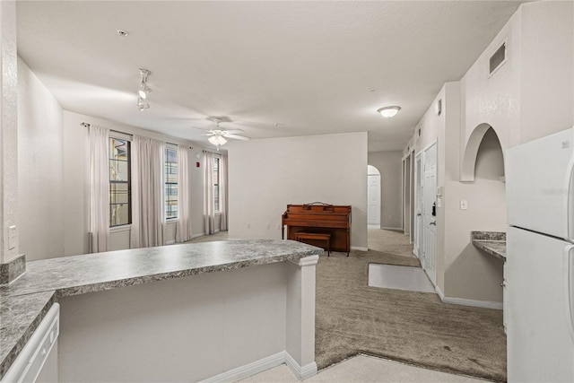 kitchen featuring ceiling fan, white appliances, light carpet, and white cabinets