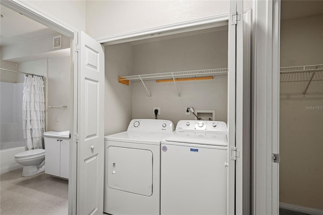 clothes washing area with washer and clothes dryer