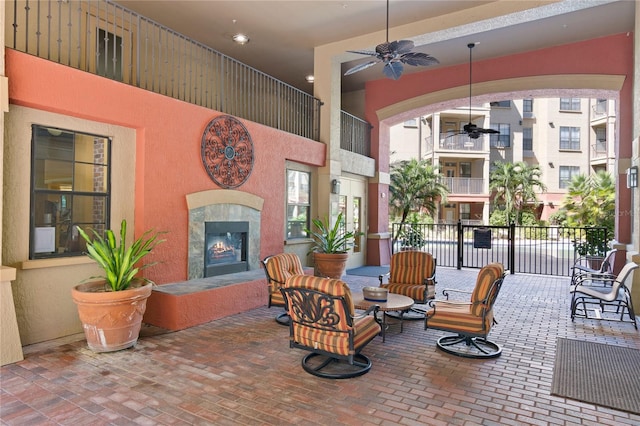 view of patio / terrace with a tile fireplace and ceiling fan